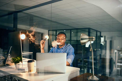 A Man Vaping Indoors in the Workplace