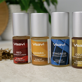 Collection of Vsavi Platinum E-Liquid Bottles on a Desk