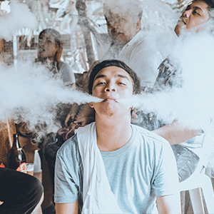 Group of People Vaping in Public During Summer