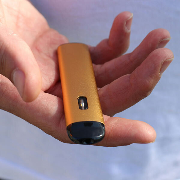 Golden Beginner Vape In Hand Hand holding golden beginner vape