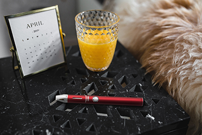 Pro Series 3X E-cigarette vaporizer on nightstand next to calendar