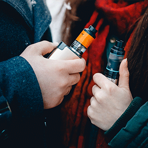 Man and Woman Holding Vape Mods