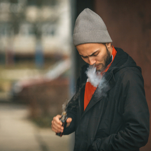 man experiencing a burnt taste when vaping