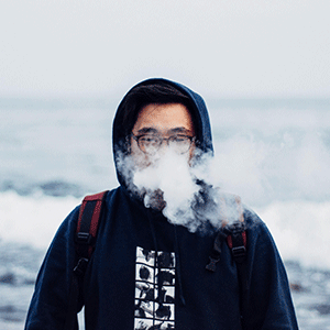 Man Vaping by the Sea