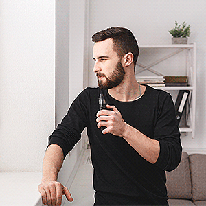 Man Vaping in His Bedroom