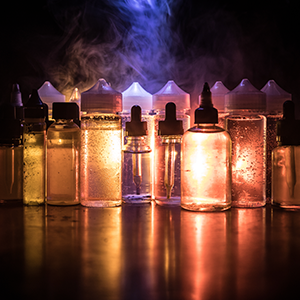 Mixture of E-Liquid Bottles Stored in a Dark Area