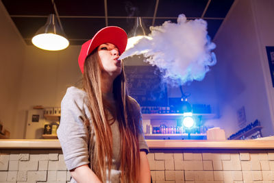 Lady Blowing  Clouds of E Cigarette Vapour