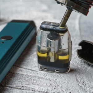 E-liquid being poured in to a refillable vape pod