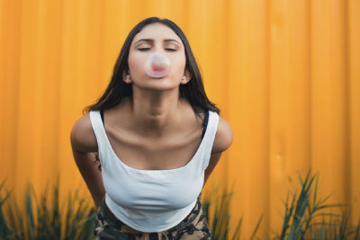 Woman blowing a bubble with chewing gum