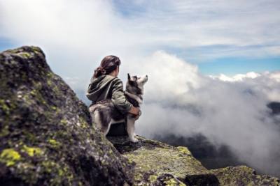 Woman on mountain with dog