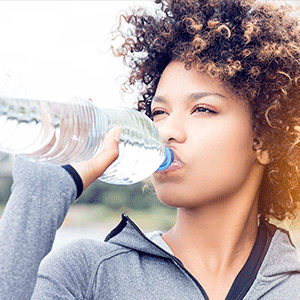 Woman Drinking Water Due to Dehydration