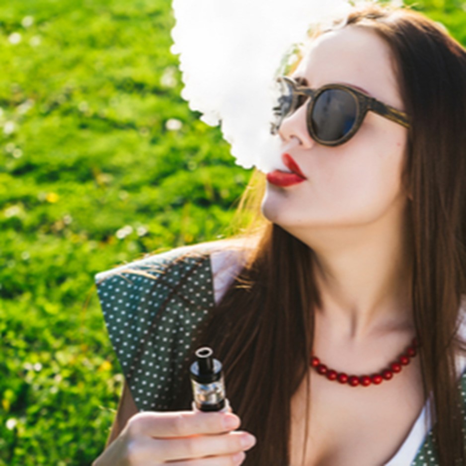 Woman Vaping a Device With Adjustable Airflow