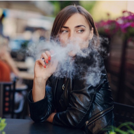 woman vaping in a public place