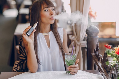 Woman Vaping mouth to lung