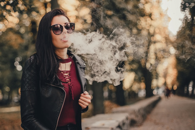 Woman Vaping With Nicotine in the Park