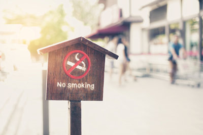 Wooden-no-smoking-sign-in-front-of-store-with-filter