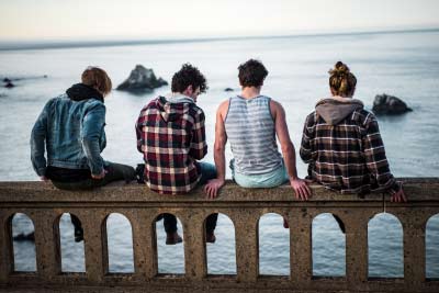 Youths on a bridge discussing e-cigarettes